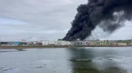Smoke pours from warehouse as fire erupts at bronze foundry in Spain