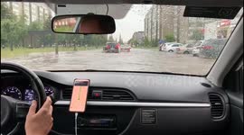 Taxi Navigates a Flooded City Street