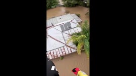 Helicopter rescues women stuck inside flooded house in Australia