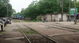 Train briefly stops to let people cross railway in Jiangxi, China