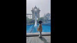 Child startled by log flume splash at amusement park in Henan, China