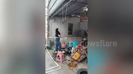 Woman shows off impressive hula hoop skills while hanging in mid-air