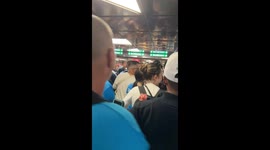 Fans chant in support of AC Milan at Garibaldi station in Milan, Italy