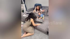Happy toddler dances while playing with mum's friends