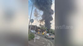 Watch as huge warehouse fire rages - with smoke seen 10 miles away
