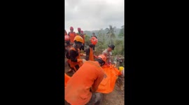 Landslide victims buried under mud are recovered in Indonesia