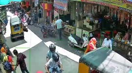 Woman's dress catches fire outside shop in India