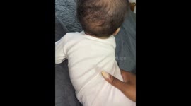 Toddler reacts with attitude to playful flip in Chicago, Illinois, USA