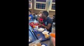 Snack lands in friend's ear during playful toss in Carmel, Indiana, USA
