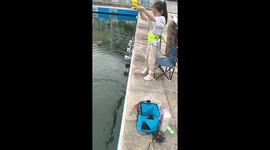 Girl catches huge fish with her toy rod