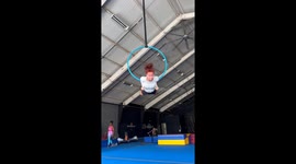 Aerial hoop mishap leaves acrobat hanging upside down in mid-air