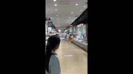 Water cascades from supermarket roof in China