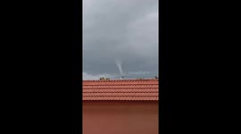 Waterspout spotted swirling above house in village