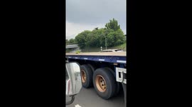 Lorry carries small toy backhoe on its long flatbed