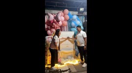 Couple opens mini-wardrobe with pink clothes for cute gender reveal party