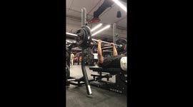 Man struggles with barbell during workout in Dammam, Saudi Arabia