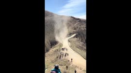 Dust devil tears along road at Mount Wutai in China