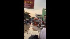 Cement mixer turns submersible as it crawls through flooded road