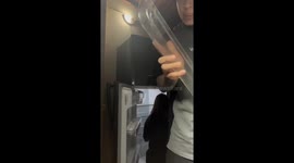 Setup mishap: Boy accidentally knocks fridge door loose, causing it to hang