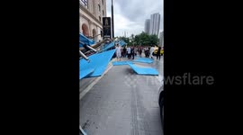 Woman sprints to safety as scaffolding collapses in China leaving 2 injured