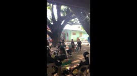 Swing music! Trombone player sways from tree as brass band rehearses
