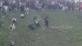 Man goes flying down hill chasing cheese in annual Cheese Rolling competition