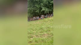 Man goes flying down hill chasing cheese in annual Cheese Rolling competition
