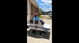 Officer Rolls Out in Cardboard Cruiser to Patrol Campus