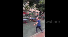 Elderly man's bizarre ping-pong style delights onlookers as he spins after every shot