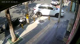 Car rips off bumper while reversing into bollards in Beijing, China