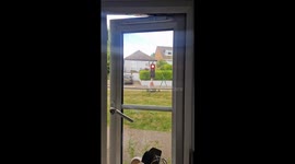Traffic light points red toward house in Hemel Hempstead, England, UK
