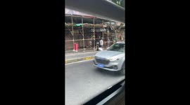 Passerby helps worker struggling to drag cart uphill in China