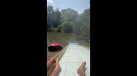 Girl perfectly times water slide to accidentally land in passing raft