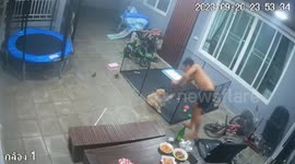 Garden chair collapses while man sits outside with dog and cool beer