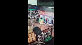 Workers soaked as store awning collapses from weight of rain