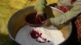 India: Women's who lives in Porajhar village makes and prepares colored powder known as Gulal