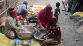 India: Women's who lives in Porajhar village makes and prepares colored powder known as Gulal