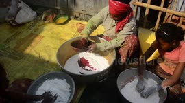India: Women's who lives in Porajhar village makes and prepares colored powder known as Gulal