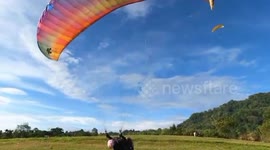 Watch this girl learn paragliding from botched take offs to smooth landing