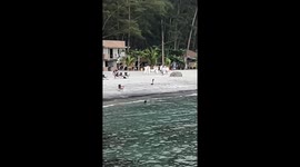 Beachgoers wearing similar white outfits embarrassed when they bump into each other