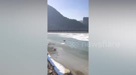 Brave pet dog runs into frozen lake to save his struggling friend