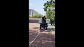 Man falls forward from wheelbarrow after sudden stop in Liaoning, China