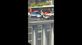 Officer carries broken bumper after crash in Hebei, China