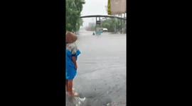Driver battle through wait-deep floods amid heavy rain in Vietnam