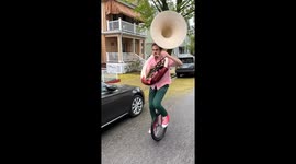 Smooth Recovery After Unicycling Tuba Player Stumbles