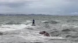Rescuer saves fisherman trapped on rock after tide rises too fast