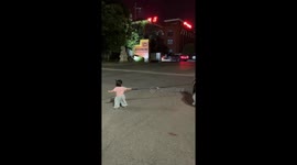 Little girl struggles to walk stubborn dog in Henan, China