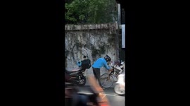Motorcycle rider pulls over to help pensioner pull his bicycle