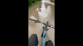 Biking mishap on flooded street in Buenos Aires, Argentina