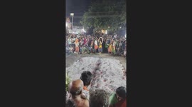 Women run across hot coals during temple festival in Kadayanallur, India